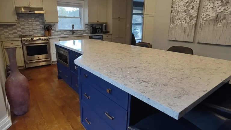 Freshly resprayed Chantilly white cabinets and a Naval blue island in a Waterdown kitchen.