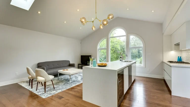 Custom kitchen and great room featuring cathedral ceilings, skylights, and floor-to-ceiling windows.