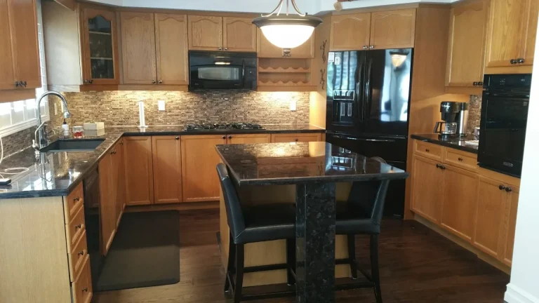 Builder's grade oak kitchen features original cabinets before the renovation.