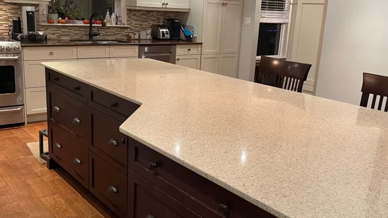 A dark island features worn countertops before the kitchen transformation.