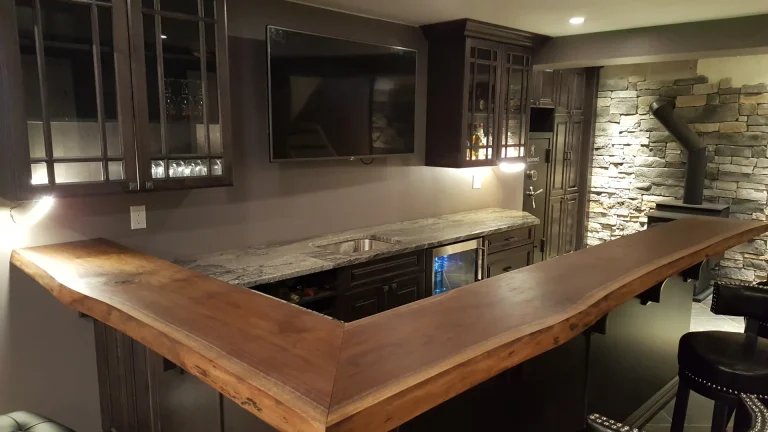 Custom dark cabinets with a live-edge bar in a Milton man cave.