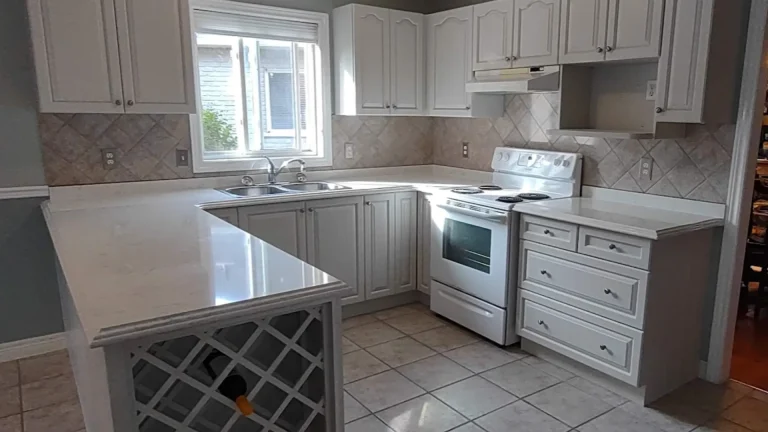 Repose Gray cabinet respray on worn maple cabinets in a downtown Burlington kitchen.