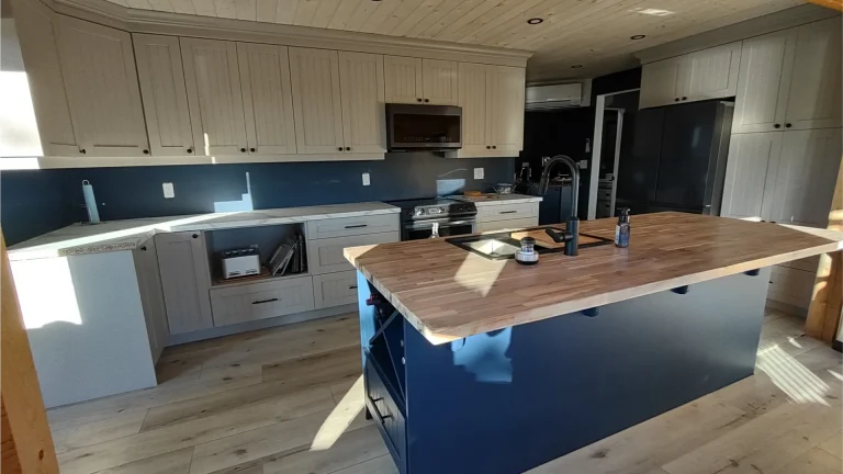 Two-tone gray kitchen cabinet respraying in a Milton home.