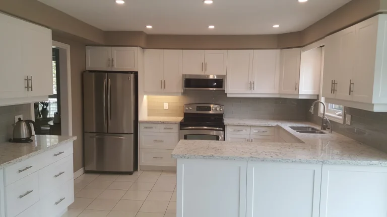 White 3DL seamless kitchen doors with K-Stone quartz countertops in a Burlington remodeling project.